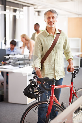 Image of Mature man, business and bicycle in office with portrait and manager of sustainable company. Ceo, boss and job with eco friendly commute in morning with smile in a creative agency of a professional