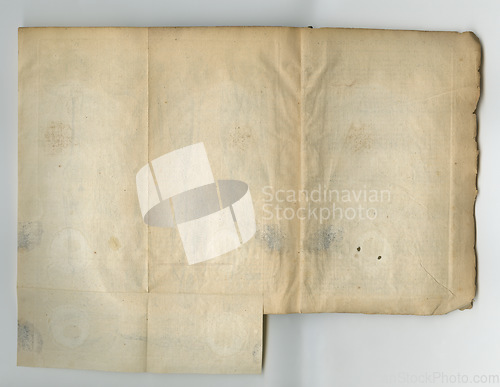 Image of Old, vintage and blank page of parchment, manuscript or history artifact for scripture or literature against a studio background. Closeup of empty historical novel, journal or worn paper for research