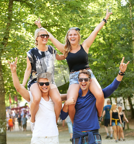 Image of Couple of friends, carrying and woman on shoulders at music festival, celebration and cheers of fans. Happy, people or rock n roll portrait at social event or men support girlfriends for fun games