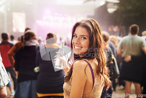 Image of Happy woman, portrait and drink at outdoor music festival with crowd for party, event or DJ in nature. Face of female person smile enjoying sound or audio at carnival, concert or performance outside