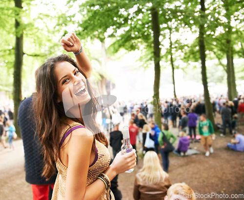 Image of Excited woman, portrait and drink at outdoor music festival with crowd for party, event or DJ in nature. Happy female person smile enjoying sound or audio at carnival, concert or performance outside