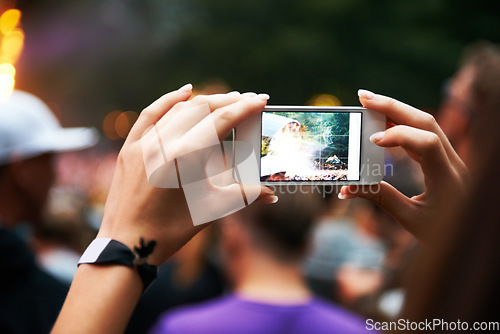 Image of Person, hands and music festival or cellphone picture or entertainment stage, party concert or crowd audience. Woman, fingers and mobile device at performance event, photography or dj celebration