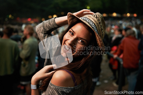 Image of Happy woman, portrait and night at music festival party, event or outdoor DJ concert. Face of female person smile with hat in evening crowd or audience at carnival, performance or summer fest outside