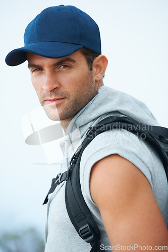 Image of Portrait, hiking and man with nature, workout and exercise with wellness, fresh air or challenge. Person, hiker or guy with backpack, hobby or activity with freedom, training or endurance with face