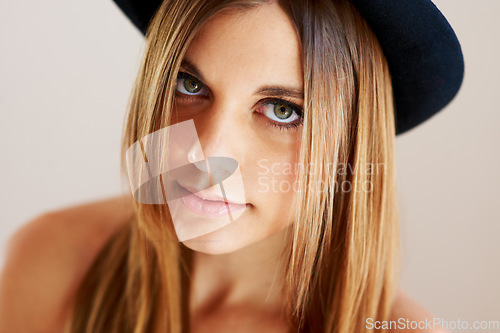 Image of Serious, hipster and portrait of woman with vintage hat, fashion or confidence in white background or studio. Retro, style and face of person in old fashioned fedora with makeup, cosmetics and beauty