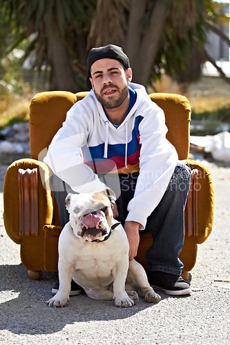 Image of Couch, city and portrait of man with dog in street for urban fashion, casual style and trendy outfit. Hip hop, pets and person on sofa in road with canine, bulldog and best friend for relaxing