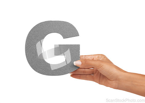 Image of Hand of woman, capital letter G and presentation of consonant isolated on white background. Character, font and person with English alphabet typeface for communication, reading and writing in studio.