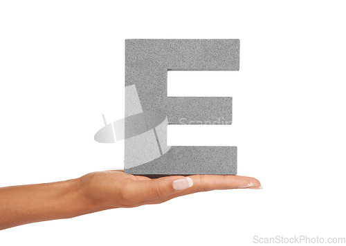 Image of Hand of woman, capital letter E and presentation of vowel isolated on white background. Character, font and palm showing English alphabet typeface for communication, reading and writing in studio.