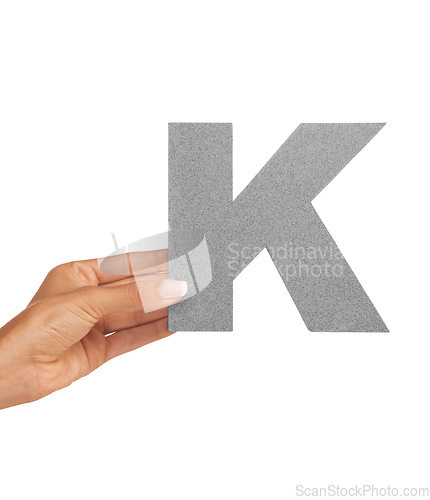 Image of Hand of woman, font letter K and presentation of consonant isolated on white background. Character, uppercase and person with English alphabet typeface in communication, reading and writing in studio