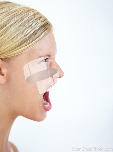 Image of Angry face, profile or woman screaming in studio at mockup space for crisis, mad emoji or reaction on white background. Frustrated model, voice and shouting loud in anger, negative expression or rage