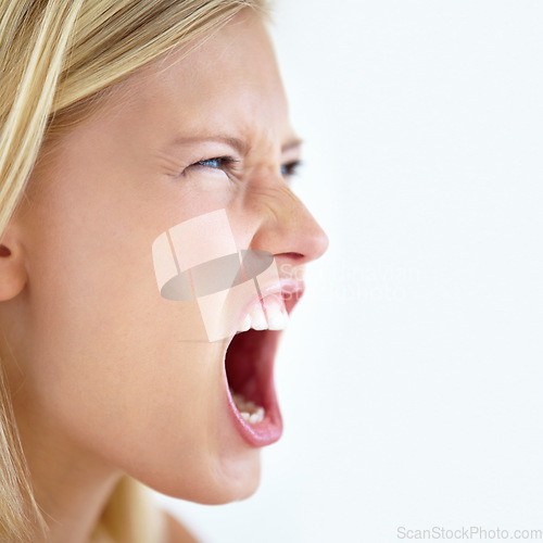 Image of Angry, face or woman screaming in studio at mockup space for crisis, mad emoji or reaction on white background. Frustrated model, shouting or voice of anger, emotional conflict or negative expression