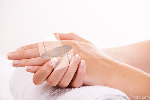 Image of Woman, hands and french manicure in salon, spa and cosmetic care, skincare and beauty. Natural growth, wellness and treatment for hygiene, closeup and nail parlour with towel, clean and maintenance