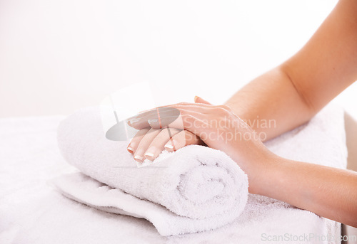 Image of Woman, hands and french manicure in beauty salon, spa and cosmetic care, skincare and tips. Natural growth, luxury and treatment for hygiene, closeup and nail parlour with towel, clean or maintenance