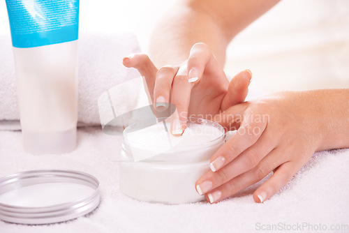 Image of Woman, hands and cream for skincare, cosmetics or beauty products in salon or spa treatment. Closeup of female person with jar or container of lotion, SPF or creme for soft skin or moisturizer