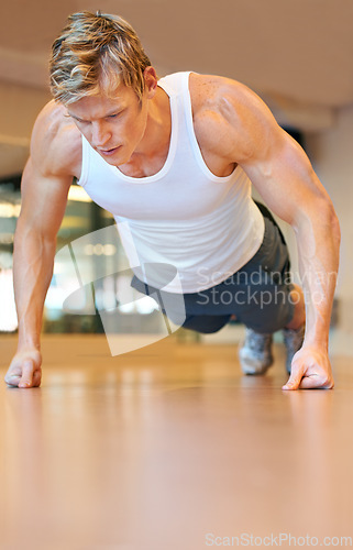 Image of Man, gym and pushup on floor, fitness and workout for muscle development, growth and results for health. Person, exercise and bodybuilder with training process, strong arms and progress for wellness