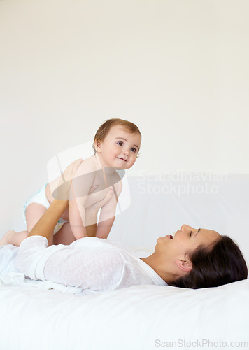 Image of Happy, baby and mother playing on bed, love and affection or bonding with toddler, smile and connection. Mom, kid and child development at home, care and support or security, motherhood and bedroom