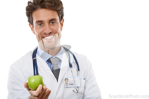 Image of Portrait, smile and apple with a man doctor in studio isolated on a white background for diet or nutrition. Food, healthcare or medical and a happy young medicine professional with a green fruit