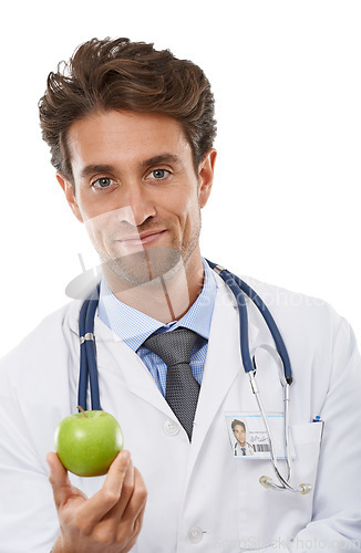 Image of Doctor, man and portrait in studio with apple and advice in healthcare for health diet in medicine. Nutritionist, face and fruit for wellness in vitamins, care and natural food by white background