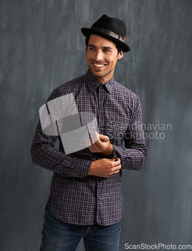 Image of Fashion, happy and man on gray background with confidence in trendy style, clothes and casual outfit. Smile, handsome and face of person on texture wall with accessory, pride and positive attitude