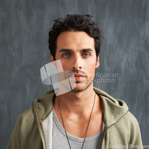 Image of Fashion, serious and portrait of man on gray background with trendy style, clothes and casual outfit. Attractive, handsome and face of person with confidence, pride and facial expression in studio