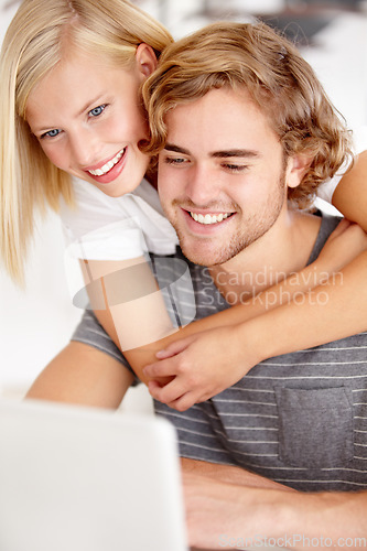 Image of Laptop, hug and a young couple in their apartment for accounting or budget planning together. Computer, love or banking research with a happy man and woman in their home for investment growth