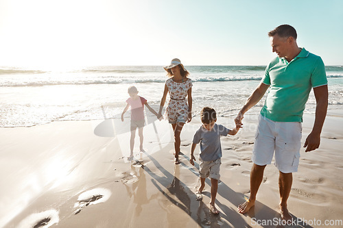 Image of Parents, children and beach or holding hands for happy summer or travel, ocean sunshine or sibling development. Man, woman and kids on sand for holiday relax walking or outdoor, clean air or vacation