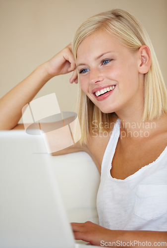 Image of Relax, laptop and happy woman on a sofa with social media, streaming or website scroll in her home. Tech, movies and female person online in living room chilling with subscription service in a house