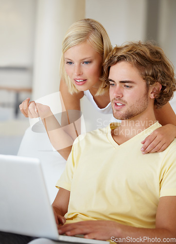 Image of Laptop, search and couple on a sofa with social media, movies or streaming at home together. Online shopping, internet and people in a living room checking ecommerce website deal for December sale