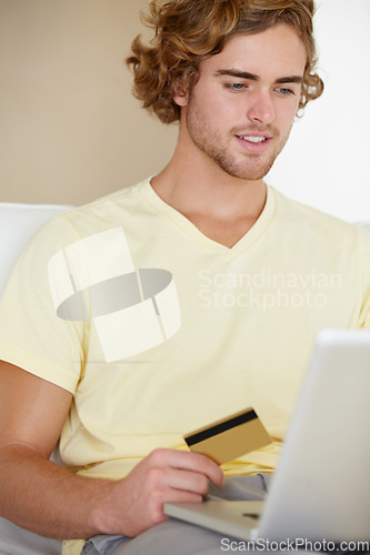 Image of Young man, credit card and laptop for online shopping, fintech payment and digital money in trading or stock market. Online user, trader or person on his computer for internet banking or cash on sofa