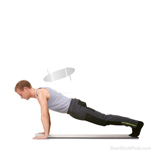 Image of Man, workout and mat in studio for push ups, fitness or exercise for healthy body, wellness or core muscle. Person, balance and training on floor or abdomen health on mockup space or white background