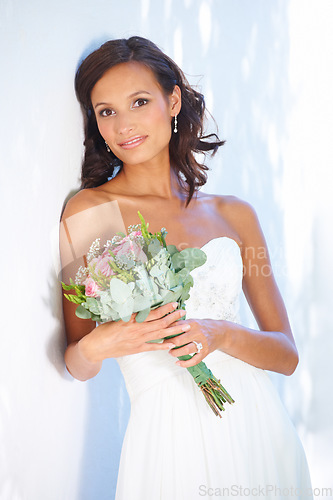 Image of Makeup, wedding and bouquet with portrait of woman at venue for love, celebration and engagement. Ceremony, reception and fashion with bride and flowers in dress for event, commitment and marriage