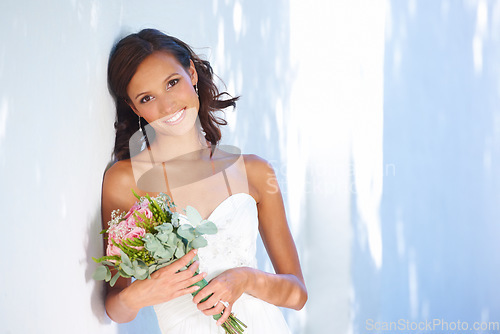 Image of Marriage, wedding and bouquet with portrait of woman at venue for love, celebration and engagement. Ceremony, reception and fashion with bride and flowers in dress for event, commitment and smile