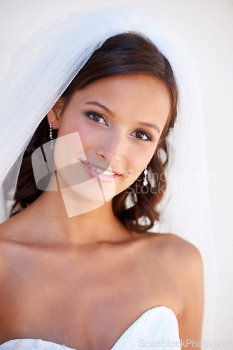 Image of Portrait, smile and a bride at her wedding for love, marriage or an event of tradition in celebration of commitment. Face, beauty and elegance with a happy young woman getting married at a ceremony