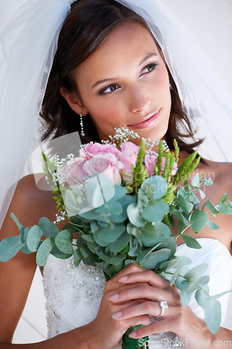 Image of Bride woman, bouquet and flowers at wedding with thinking, pride and commitment at event, celebration and party. Girl, marriage and floral plants for love, roses or vision with smile, ideas or memory