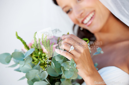 Image of Wedding, flowers and ring with woman and bouquet for beauty, celebration and engagement. Jewelry, smile and commitment with hands of bride at venue for marriage, ceremony and save the date event
