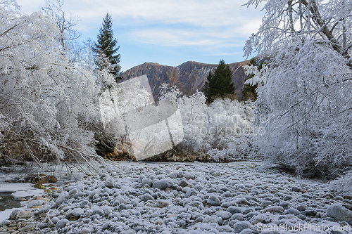 Image of Frost-Covered Landscape With River and Mountains on a Winter Mor