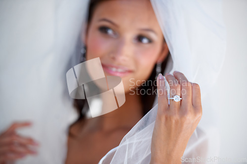 Image of Diamond, wedding ring and hand of bride with jewellery and pride for commitment, celebration or marriage. Bridal, aesthetic and woman closeup with engagement jewelry, fashion and veil fabric