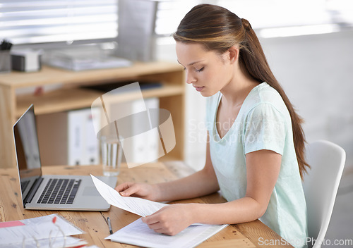 Image of Business woman, reading documents and planning on laptop for research, review and human resources management in office. Young worker with paperwork, contract analysis and computer for job information