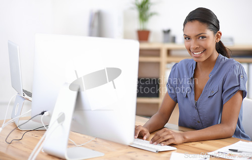 Image of Business woman, portrait and typing at computer in office for online research, website review or planning connection in creative startup. Happy african designer, desktop and working in digital agency