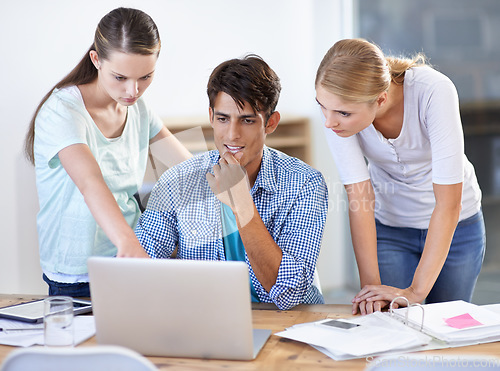 Image of Teamwork, laptop or designers in meeting for research, news or planning together in office. Collaboration, startup or creative people with documents or info on online blog website for editing project