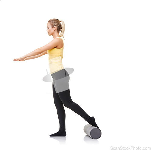 Image of Studio, foam roller and woman training for leg strength challenge, balance or rehabilitation fitness. Pilates, mockup space or girl workout for body wellness, recovery or activity on white background