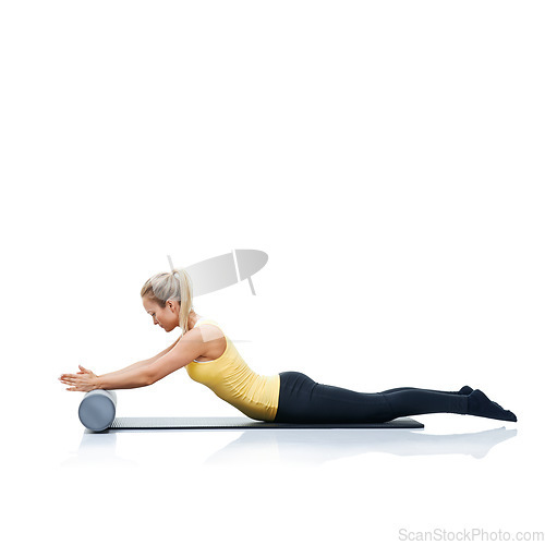 Image of Pilates, foam roller and woman in a studio for workout, stretching or gym routine with yoga mat. Stability, balance and young female athlete from Australia with body exercise by white background.