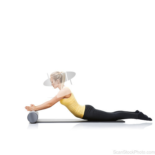 Image of Health, foam roller and woman in a studio for exercise, stretching or gym routine with yoga mat. Stability, balance and young female athlete from Australia with body workout by white background.