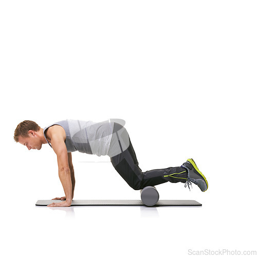 Image of Pilates, foam roller and man in a studio for exercise, stretching or gym routine with yoga mat. Stability, balance and young male athlete from Australia with body workout by white background.