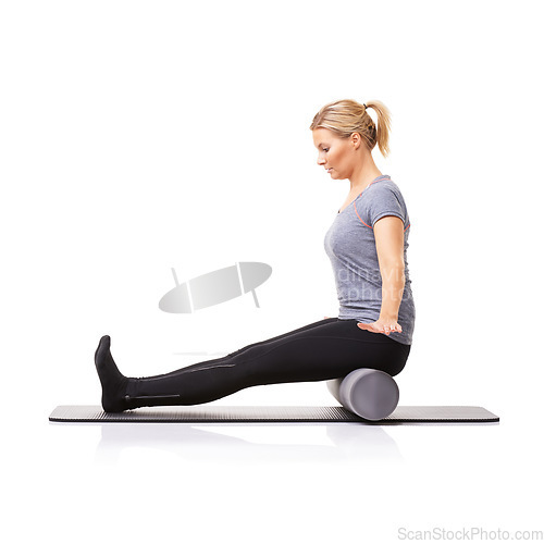 Image of Pilates, foam roller and woman in a studio for exercise, stretching or gym routine with yoga mat. Stability, balance and young female athlete from Australia with body workout by white background.