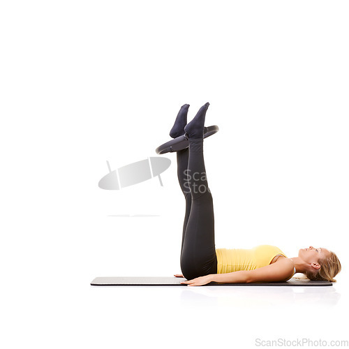 Image of Woman, pilates ring and legs for workout on yoga mat for resistance training, strong thighs or studio white background. Female person, equipment for muscle flexibility or exercise, health or mockup