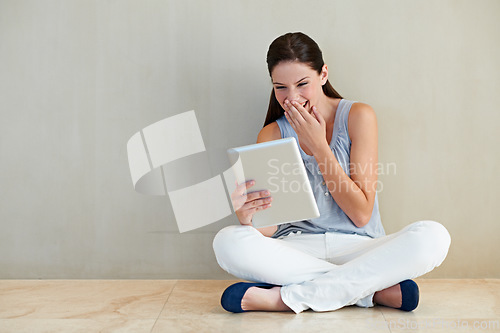 Image of Happy woman, tablet and laughing for funny joke, social media or meme sitting on floor at home. Female person, brunette or freelancer smile and giggling with technology for humor or comedy on mockup