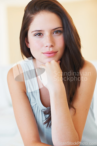 Image of Portrait, beauty and natural with a young woman in the bedroom of her home to relax in the morning. Face, break and leisure with a happy young person alone in her apartment for weekend time off
