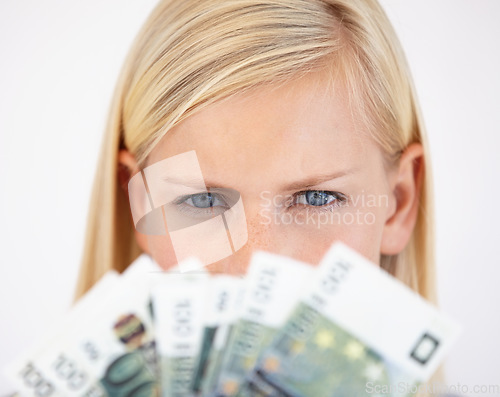 Image of Eyes, finance and woman serious about money in studio on a white background for tax, salary or increase. Accounting, economy or payment and a young person with cash for bank savings or growth