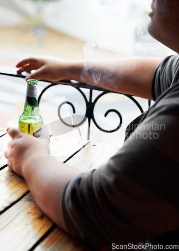 Image of Outdoor, smoking and man with a beer, relax and weekend break at a restaurant, alcohol and pub. Person, outside and guy with cigarette, tobacco and drink with habit, bottle and peaceful with smoker